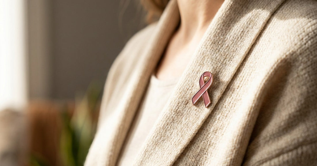 Pink awareness ribbon pinned to a cardigan, a Desert Harvest Breast Cancer Awareness post