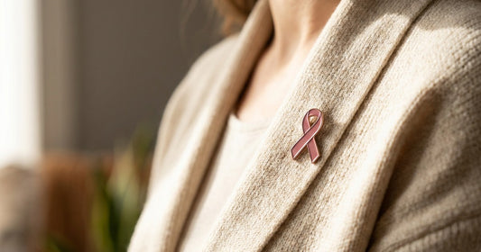 Pink awareness ribbon pinned to a cardigan, a Desert Harvest Breast Cancer Awareness post