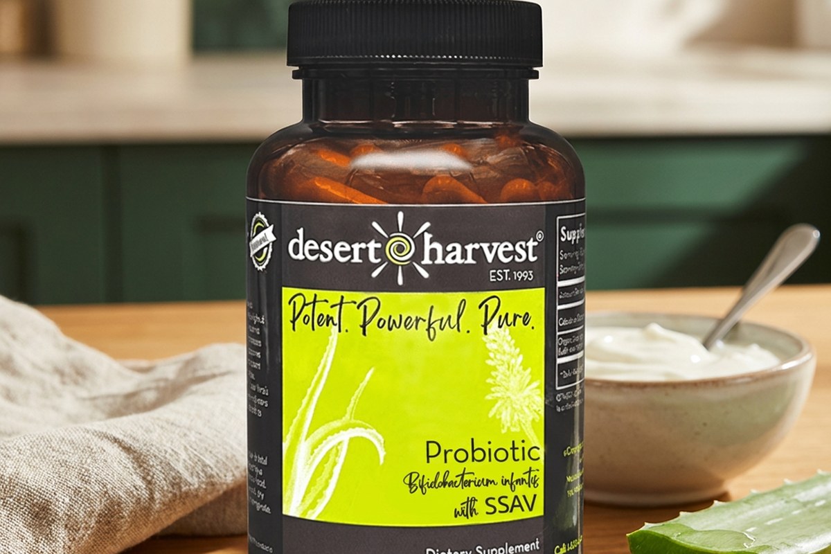 Desert Harvest Probiotic capsules with fresh Aloe Vera leaf and yogurt on a warm surface