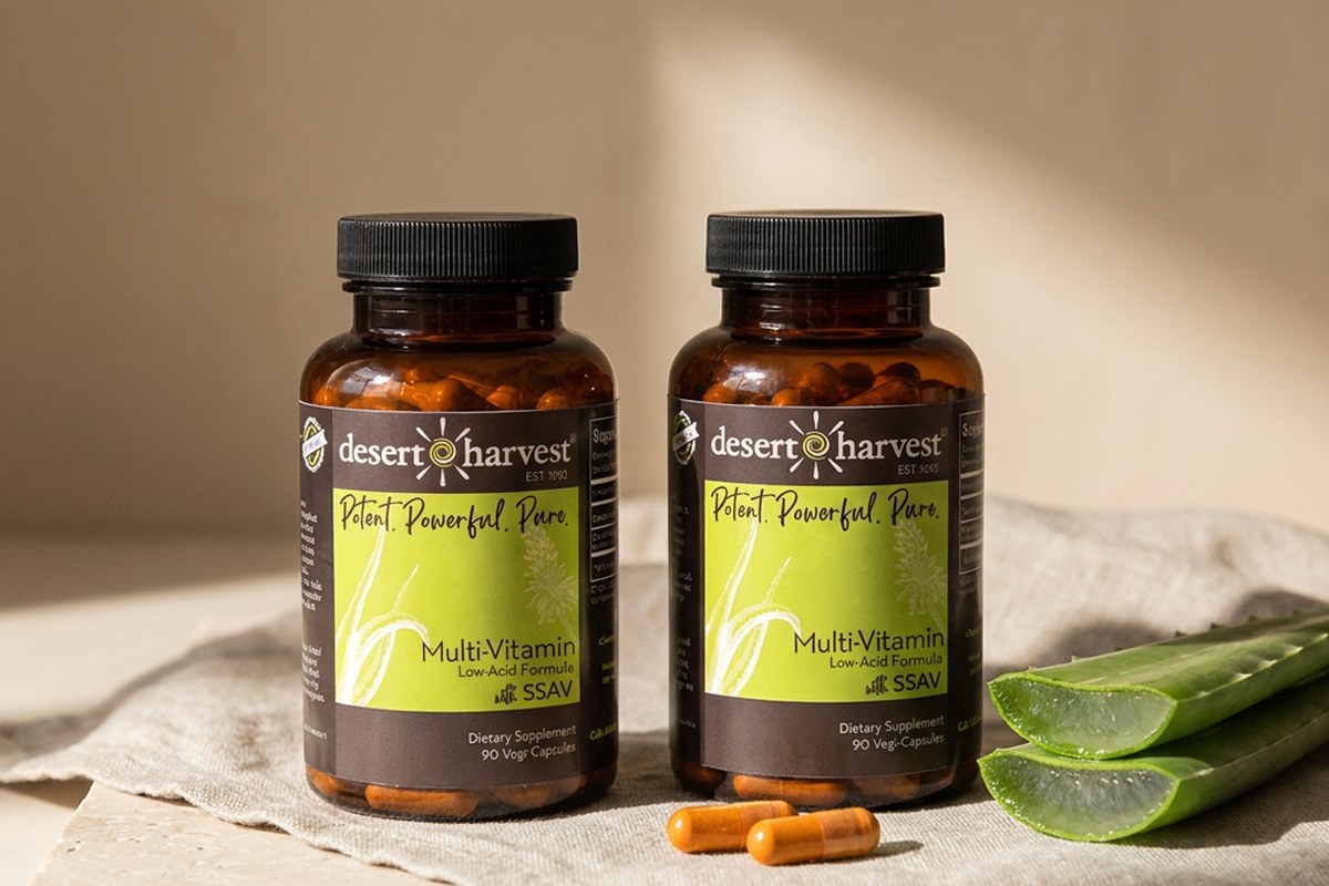 Desert Harvest Multi-Vitamin Low Acid and Magnesium bottles with fresh Aloe Vera on a linen surface