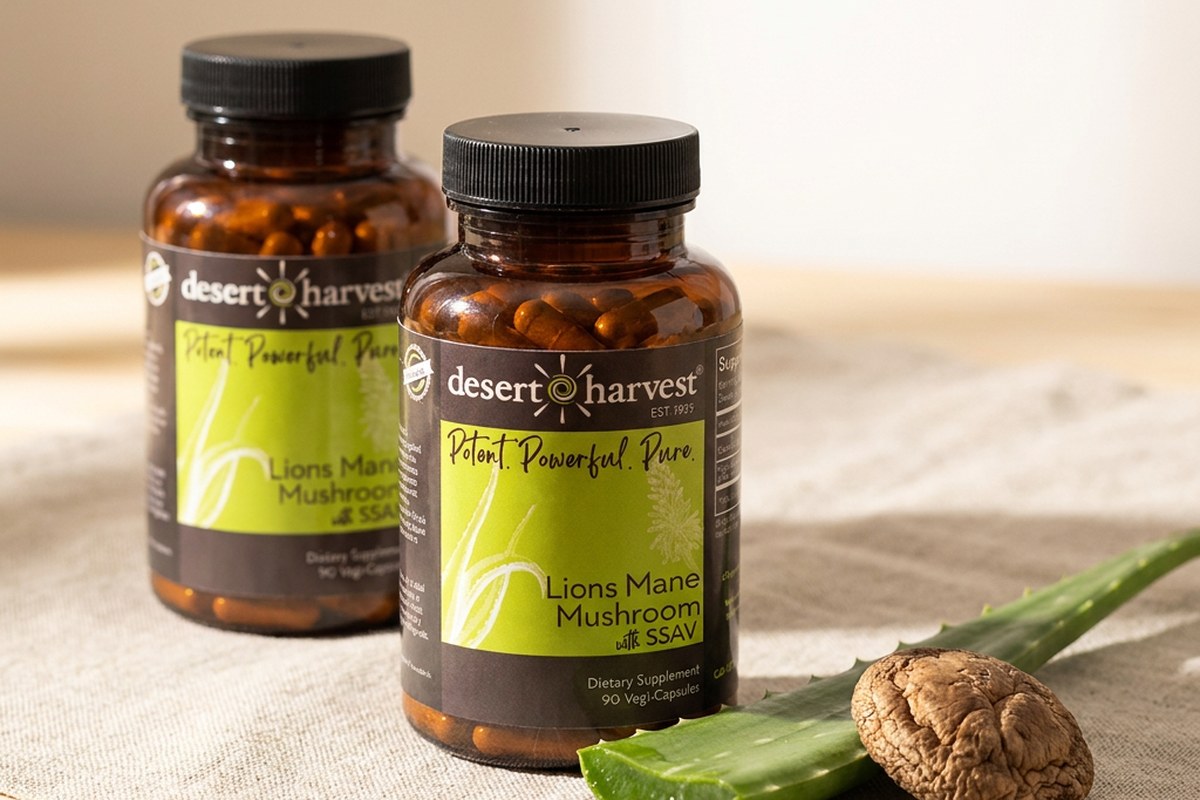 Desert Harvest Turkey Tail and Lion's Mane bottles with Aloe Vera leaf on linen in warm light