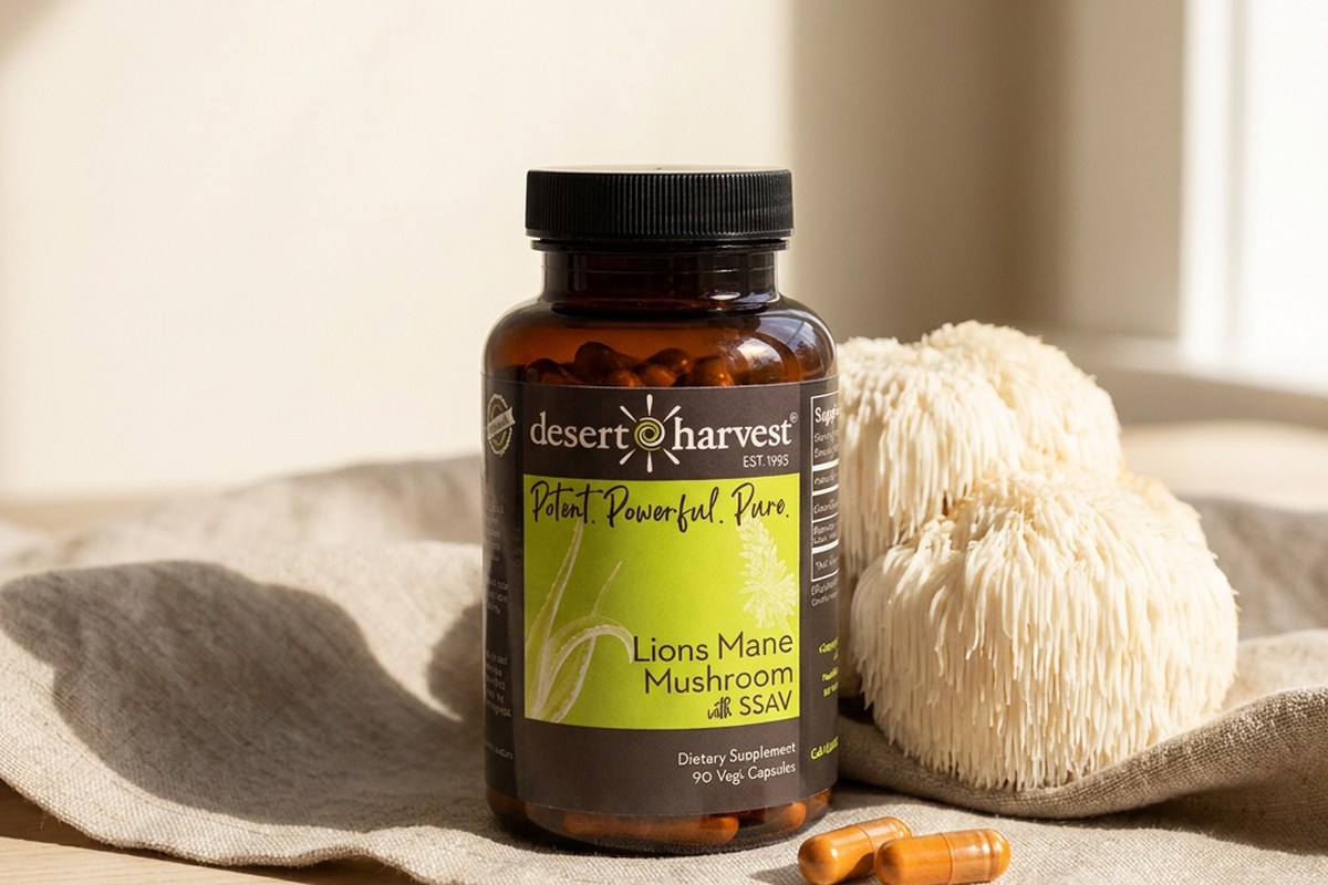 Desert Harvest Lion's Mane bottle beside a fresh Lion's Mane mushroom on warm linen