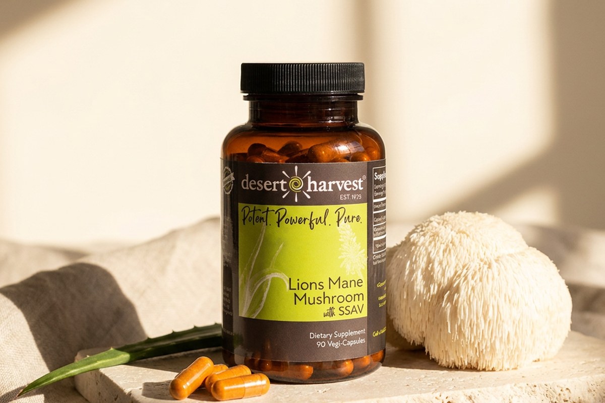 Desert Harvest Lion's Mane bottle with fresh mushroom and capsules on pale stone