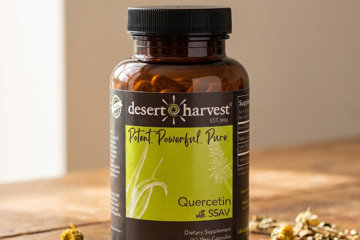 Desert Harvest Quercetin 90 capsules bottle on a wooden table with yellow flower buds