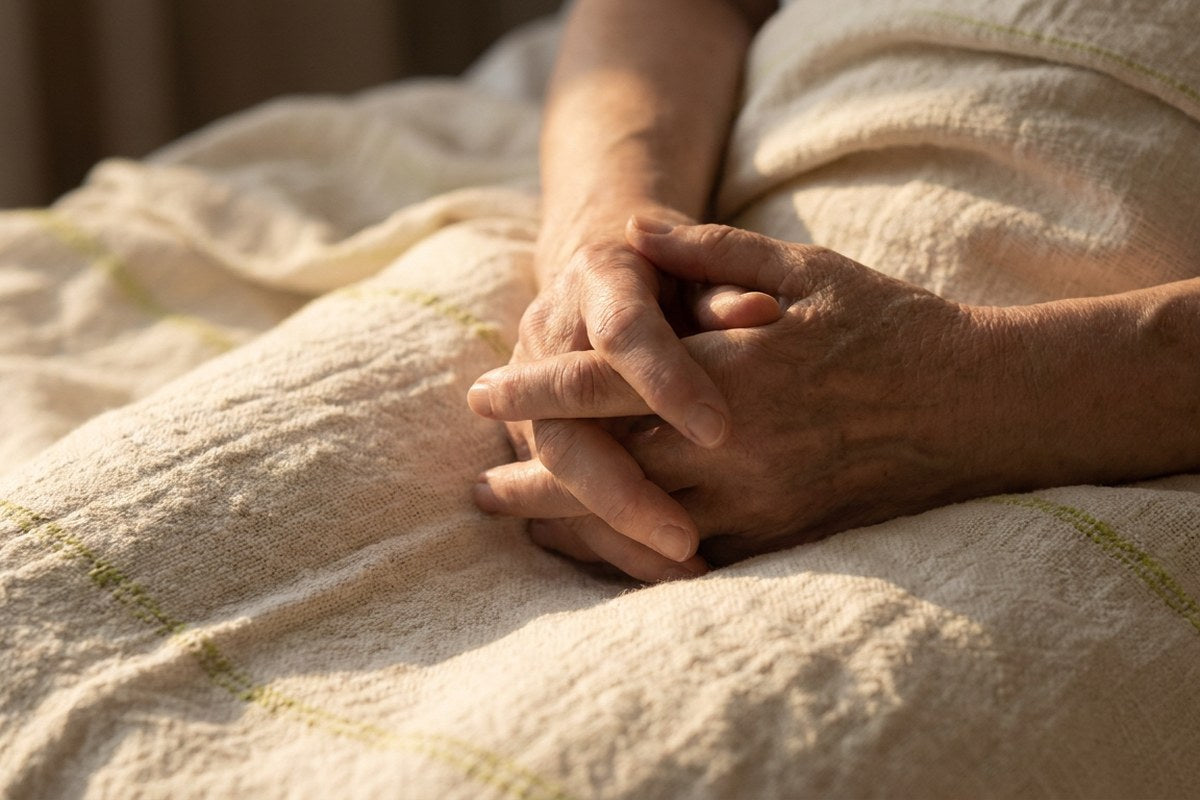 Two hands gently clasped on a soft blanket, comfort and partner connection with IC/BPS, Desert Harvest