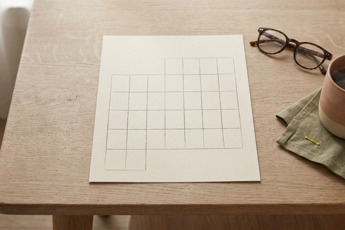 A blank calendar grid on a desk representing tracking symptoms, a Desert Harvest wellness graphic